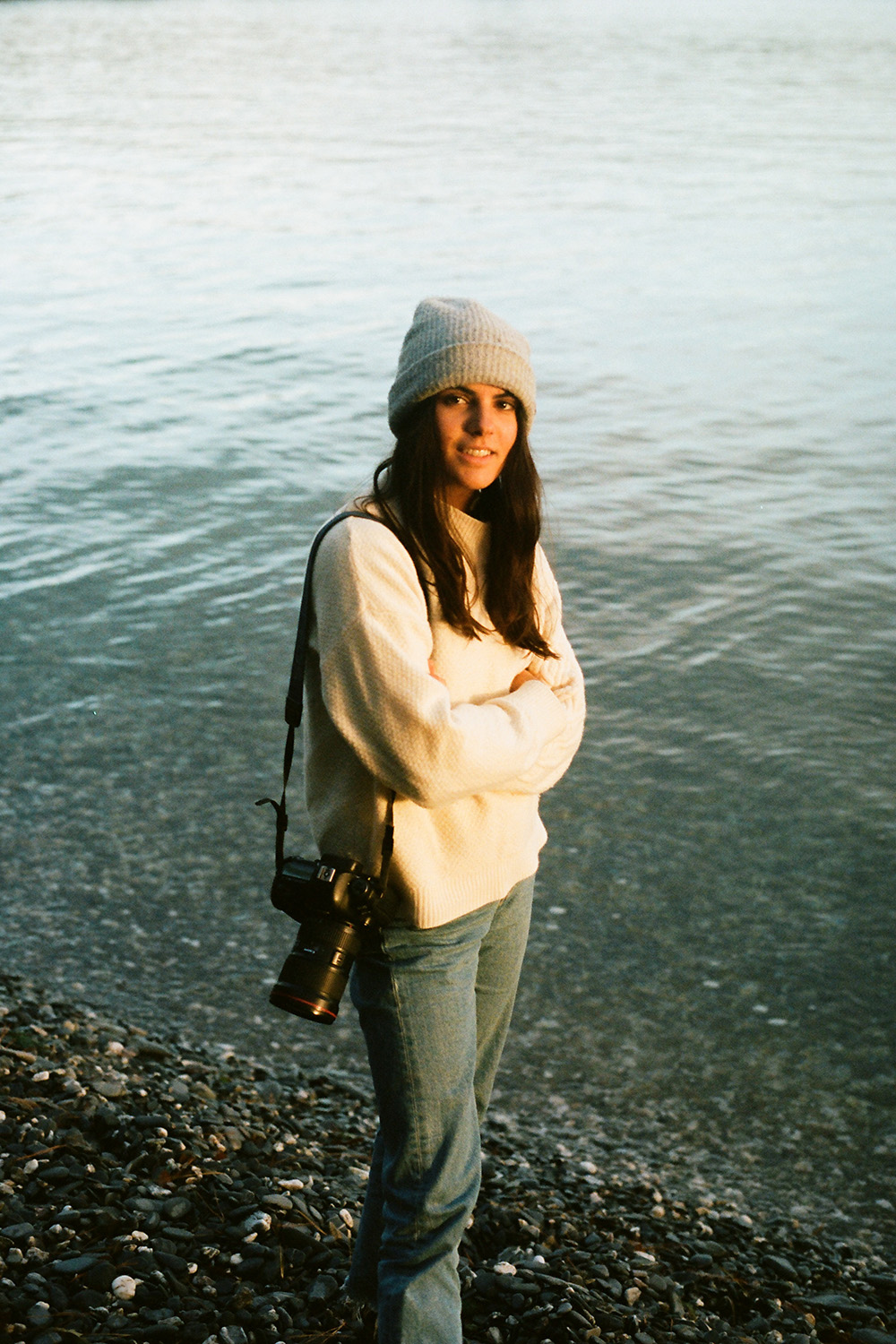 Photo of Giulia posing, with her camera as a sling on her shoulder